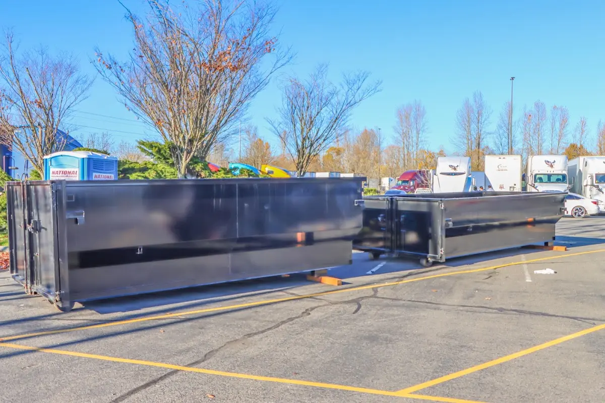 Professional dumpster rental service with roll-off container on residential driveway in South Hanover